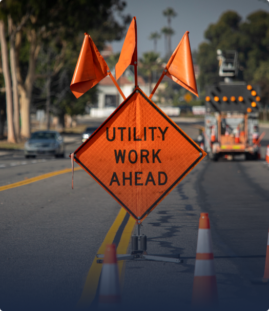 utility work ahead orange sign in roadway