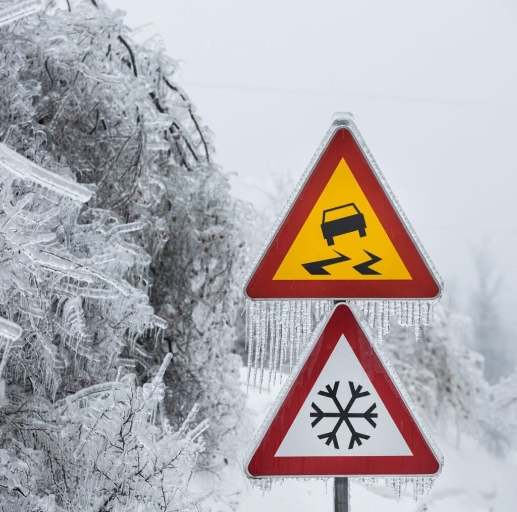 close up of ice covered road signs