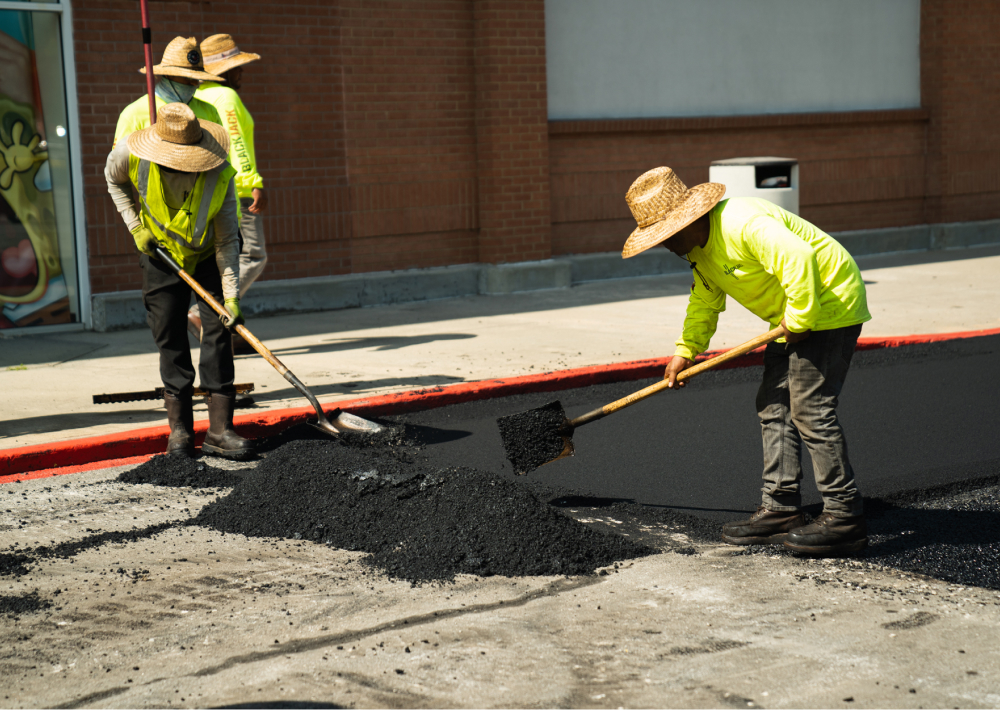 contractors paving roadway with asphalt