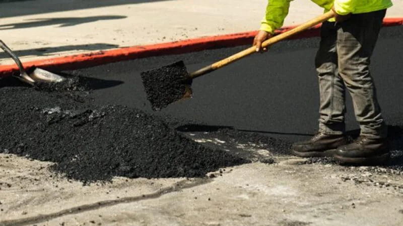 laying down asphalt in parking lot