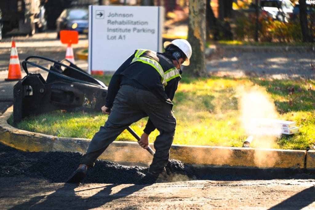 paving contractor working on asphalt pavement