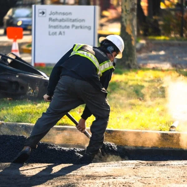 paving contractor working on asphalt pavement
