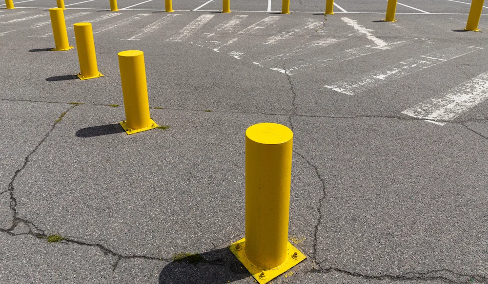yellow bollards in a parking lot