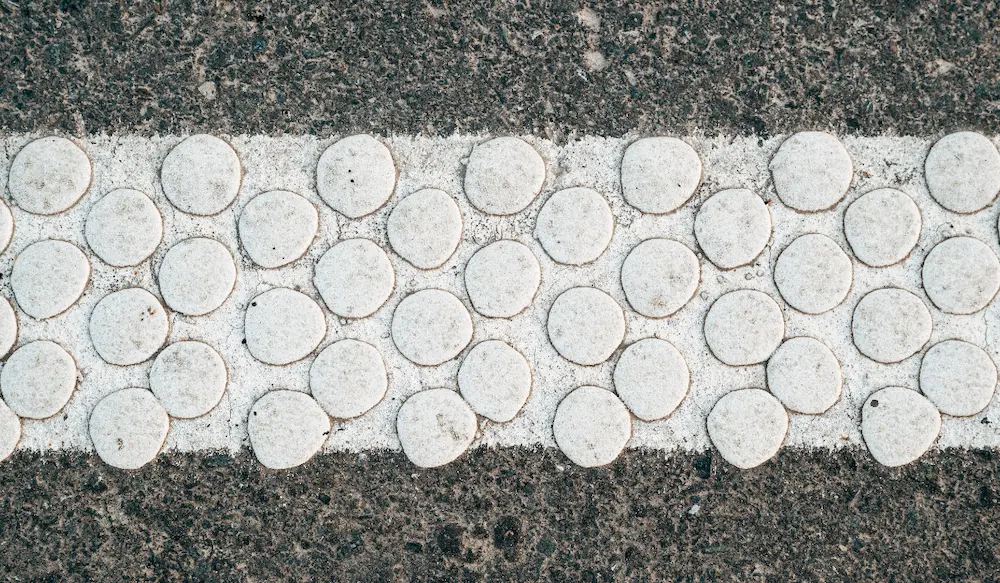 white slip resistant bumps in the pavement