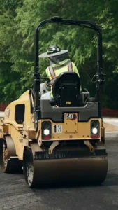 pave america employee on an asphalt roller