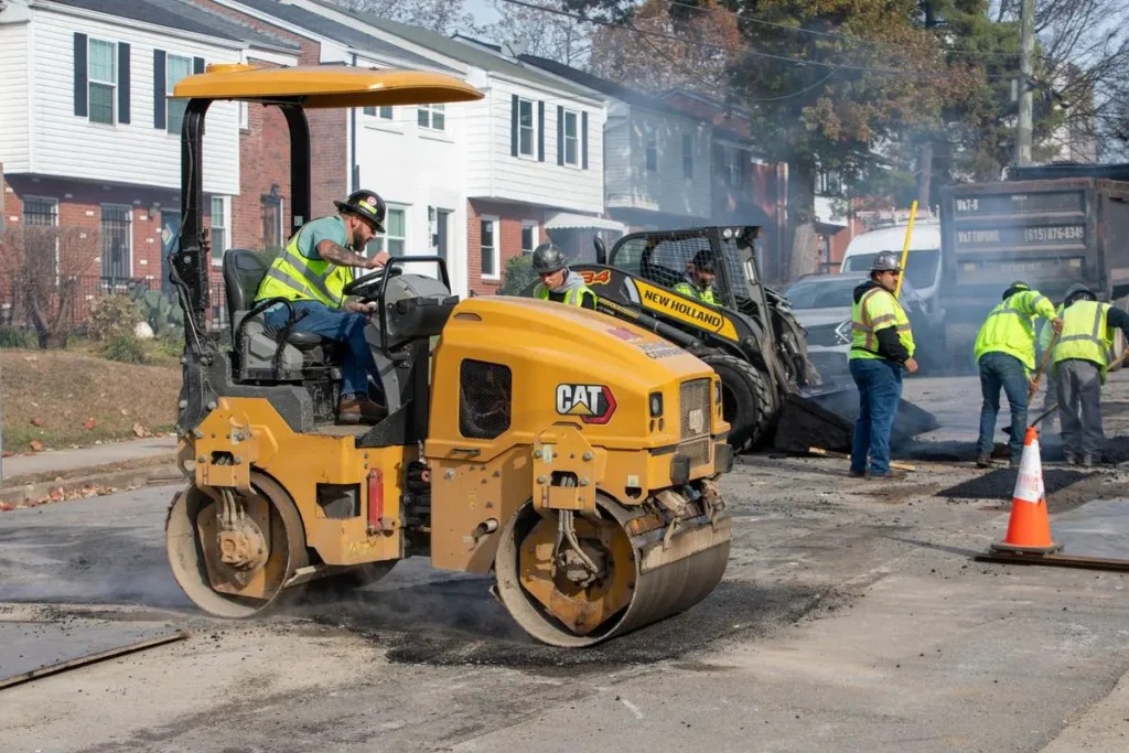 pave america employee on an asphalt roller