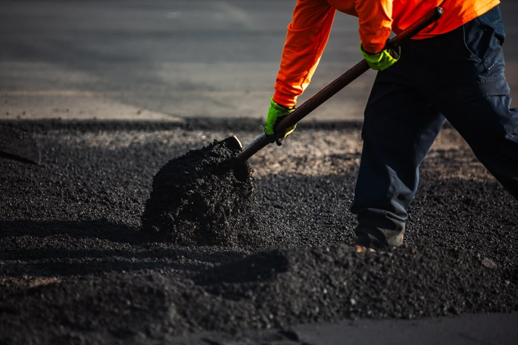 person laying asphalt 