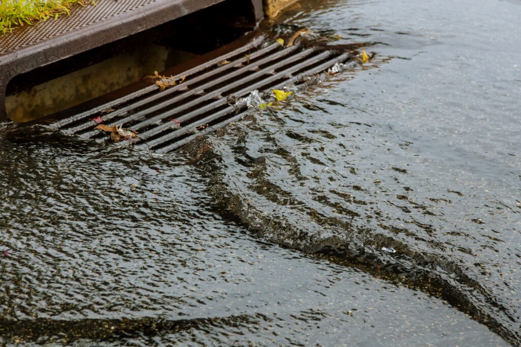 water flowing into a storm drain 