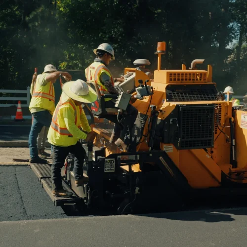 PKS paving employees operating a machine