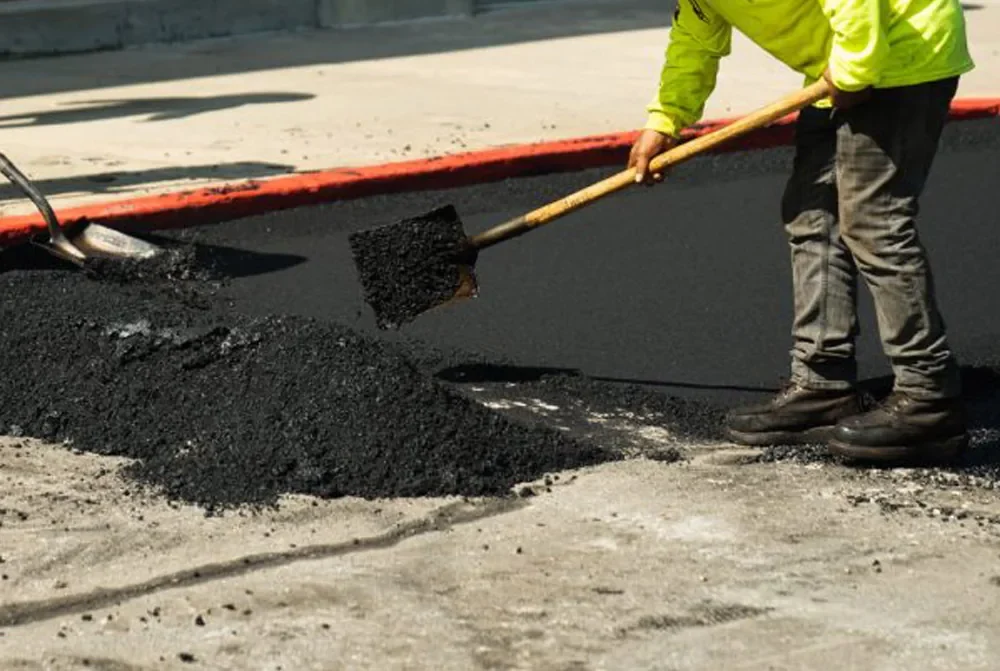 laying down asphalt in parking lot