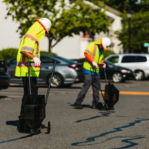 brothers paving crew members filling in cracks in pavement