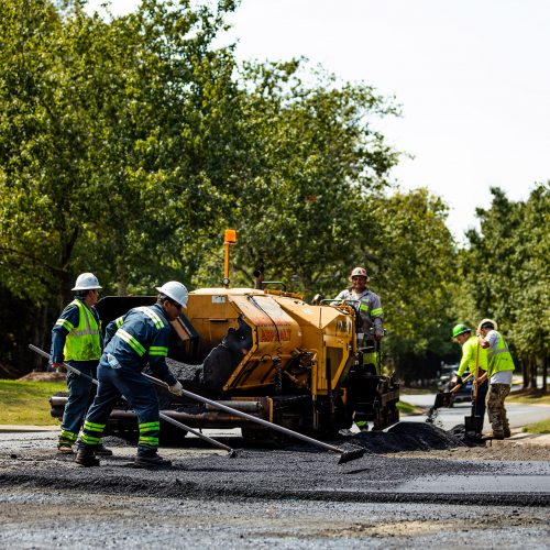 Carolina Asphalt employees performing asphalt paving services at commercial project site.