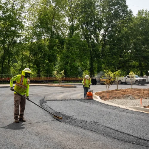 blackjack paving employees raking asphalt