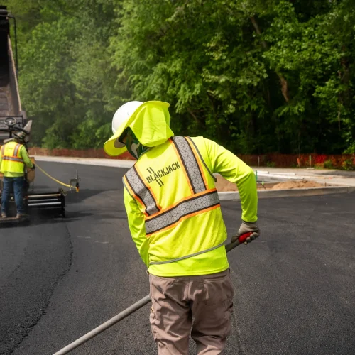 blackjack paving employee raking asphalt