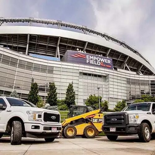 National Pavement Partners trucks in front of Empower Field.