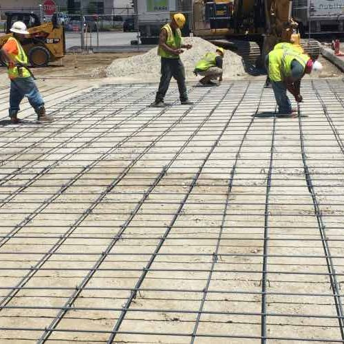 PKS Paving employees working on concrete on commercial job site.
