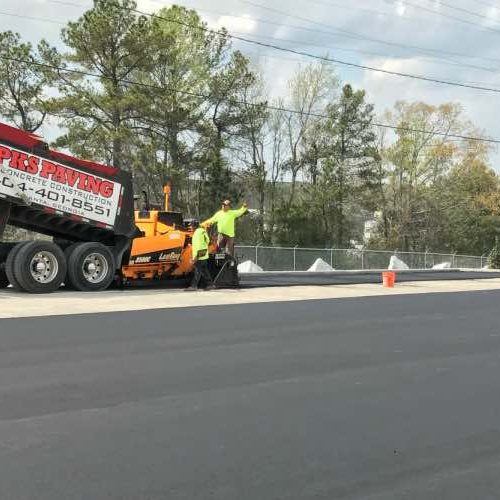 PKS Paving on commercial job site with branded truck.