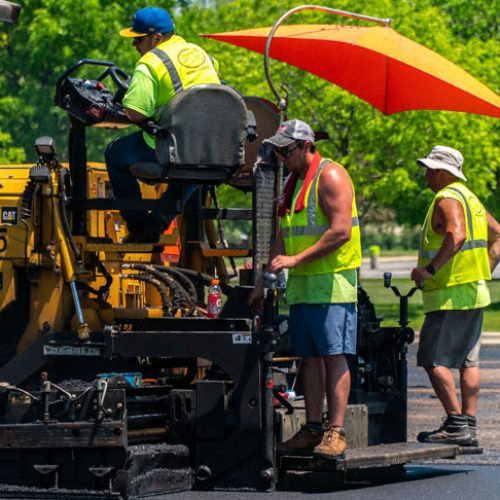 PLM Paving & Concrete employees on commercial job site.