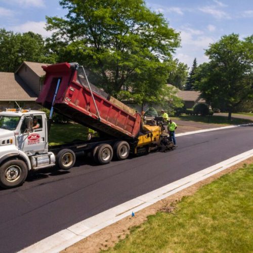 PLM Paving & Concrete truck on job site.