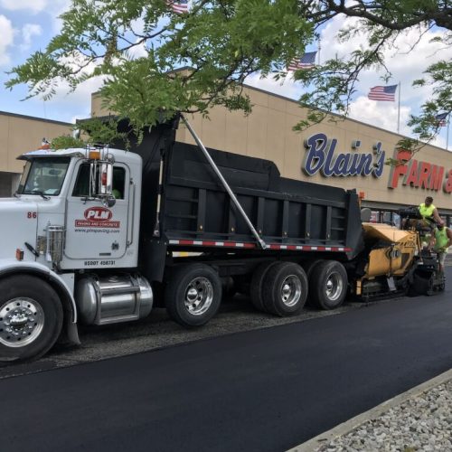 PLM Paving & Concrete in front of commercial retail building