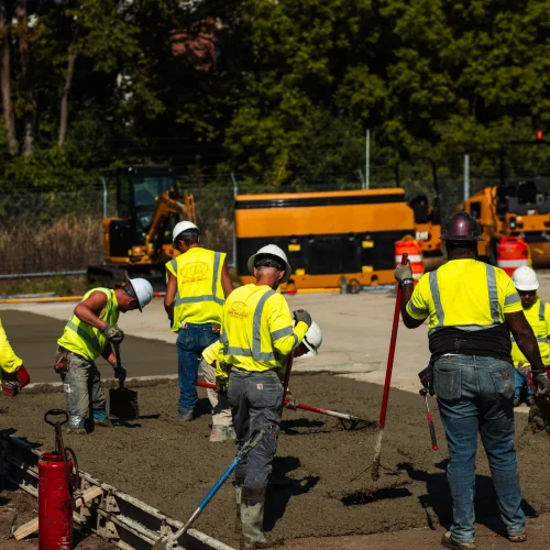 PLM Paving employees pouring concrete