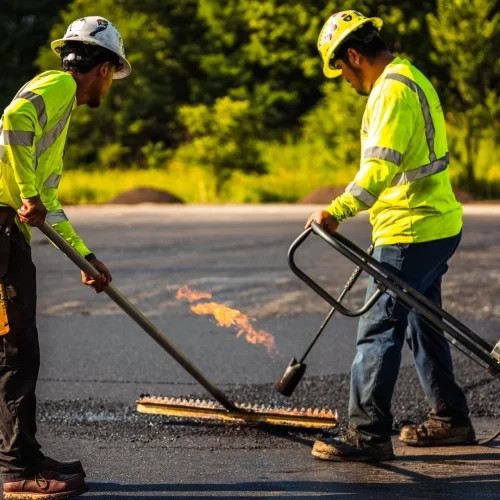 PLM Paving employees raking asphalt