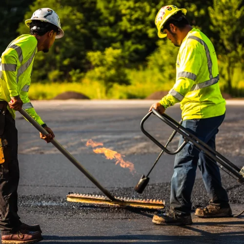 PLM Paving employees raking asphalt