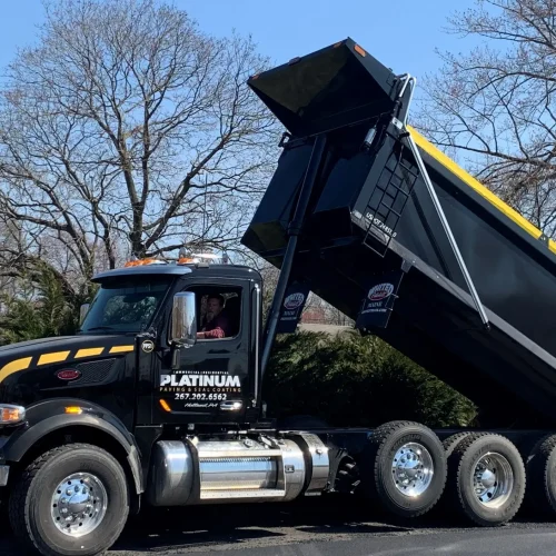 Platinum Paving truck on commercial job site.