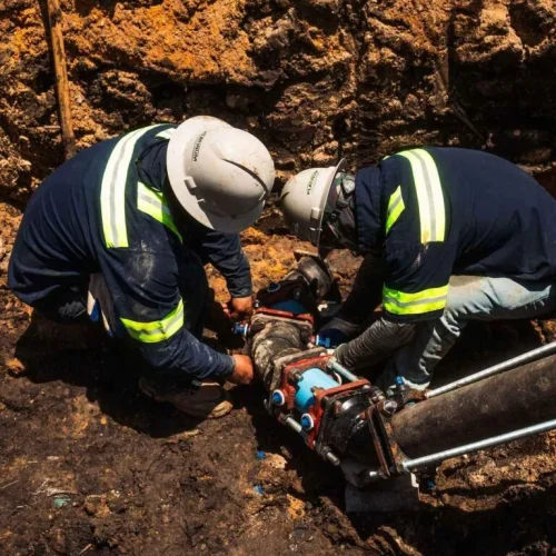 Platinum Paving employees working on pipes.