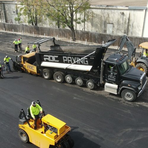 RDC Paving employees and truck working on asphalt.