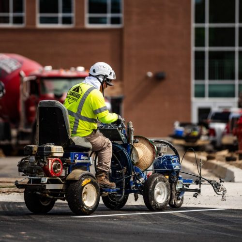 Standard Pavement & Concrete employee on paving equipment.