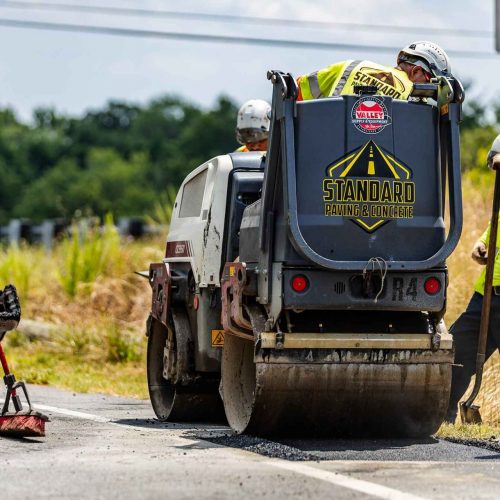 Standard Pavement & Concrete equipment with company logo.