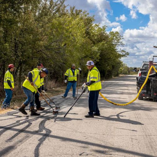 alpha paving employees crack filling a pavement
