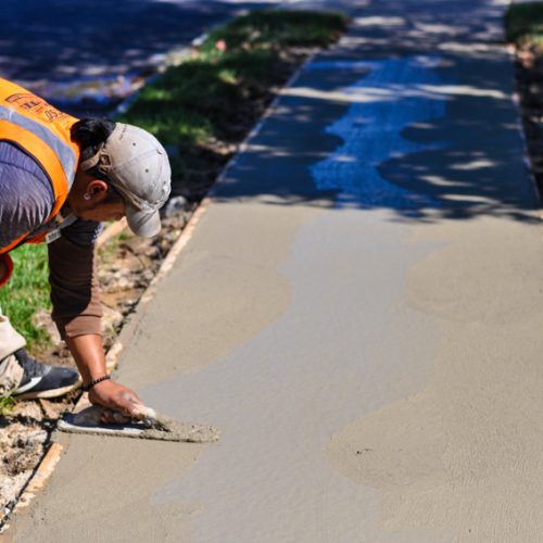 Eosso Brothers Paving employee smoothing concrete.