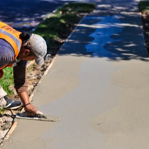 Eosso Brothers Paving employee smoothing concrete.