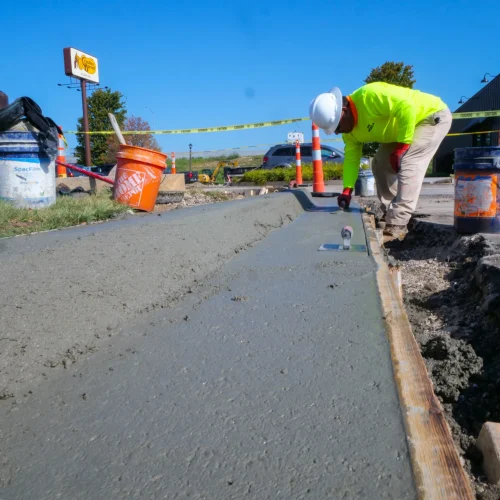 Kansas Asphalt employee smoothing concrete.