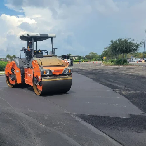 Landmark Paving flattening asphalt on commercial jobsite.