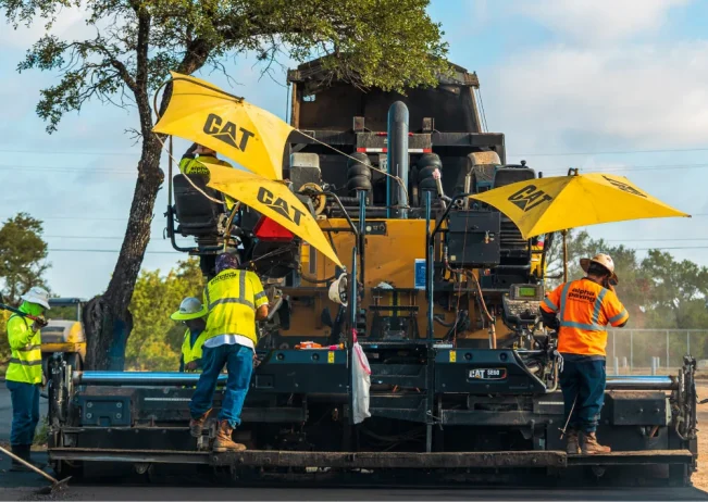 Asphalt paving, rolling, and compacting new asphalt